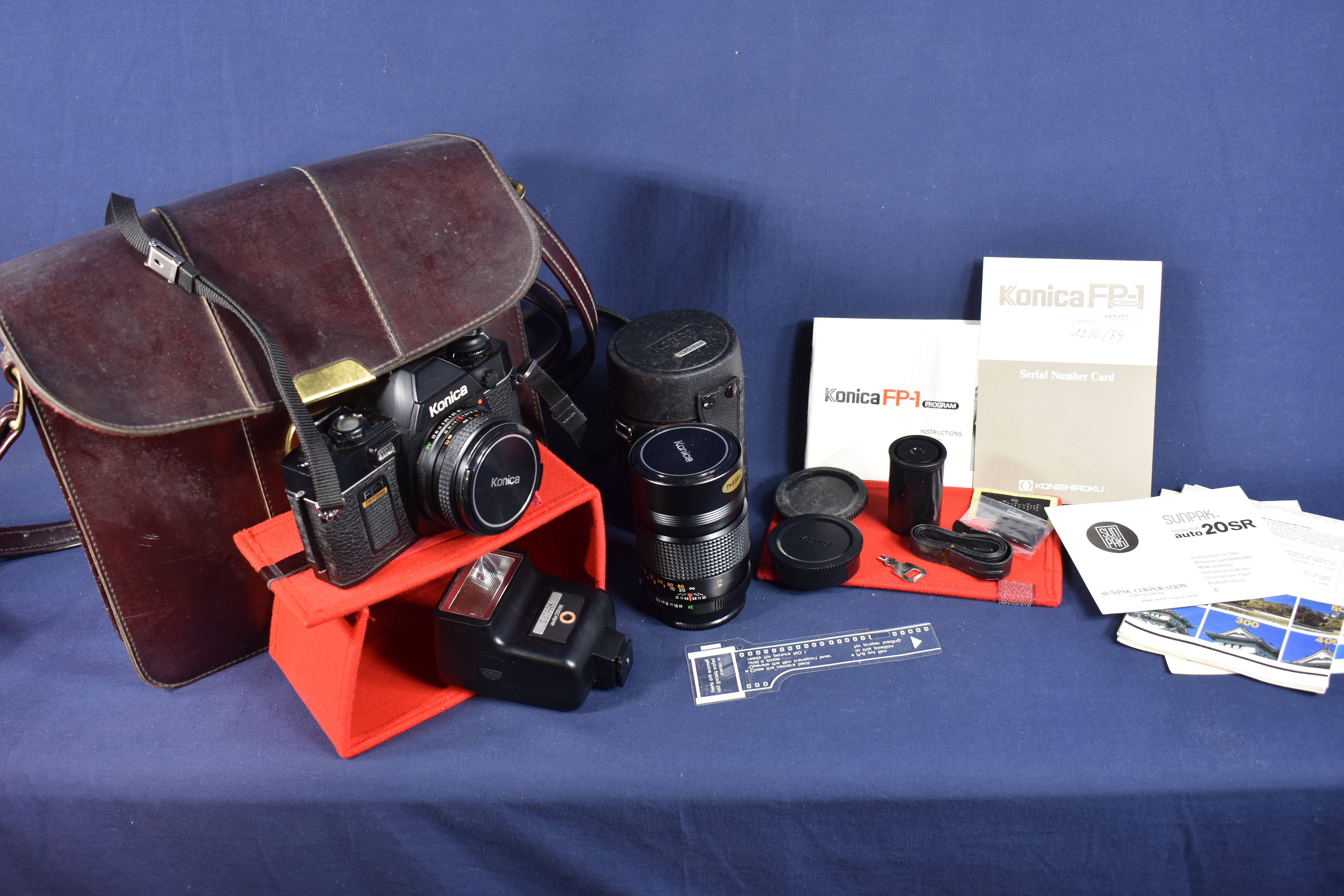 Appareil photos argentiques KONICA FP-1, dans son étui d'origine, muni de sa clé + objectif KONICA 135/F3.5 complet de ses notices + flash SUNPAK auto 20 SR. Bon état - Vue 15 - 