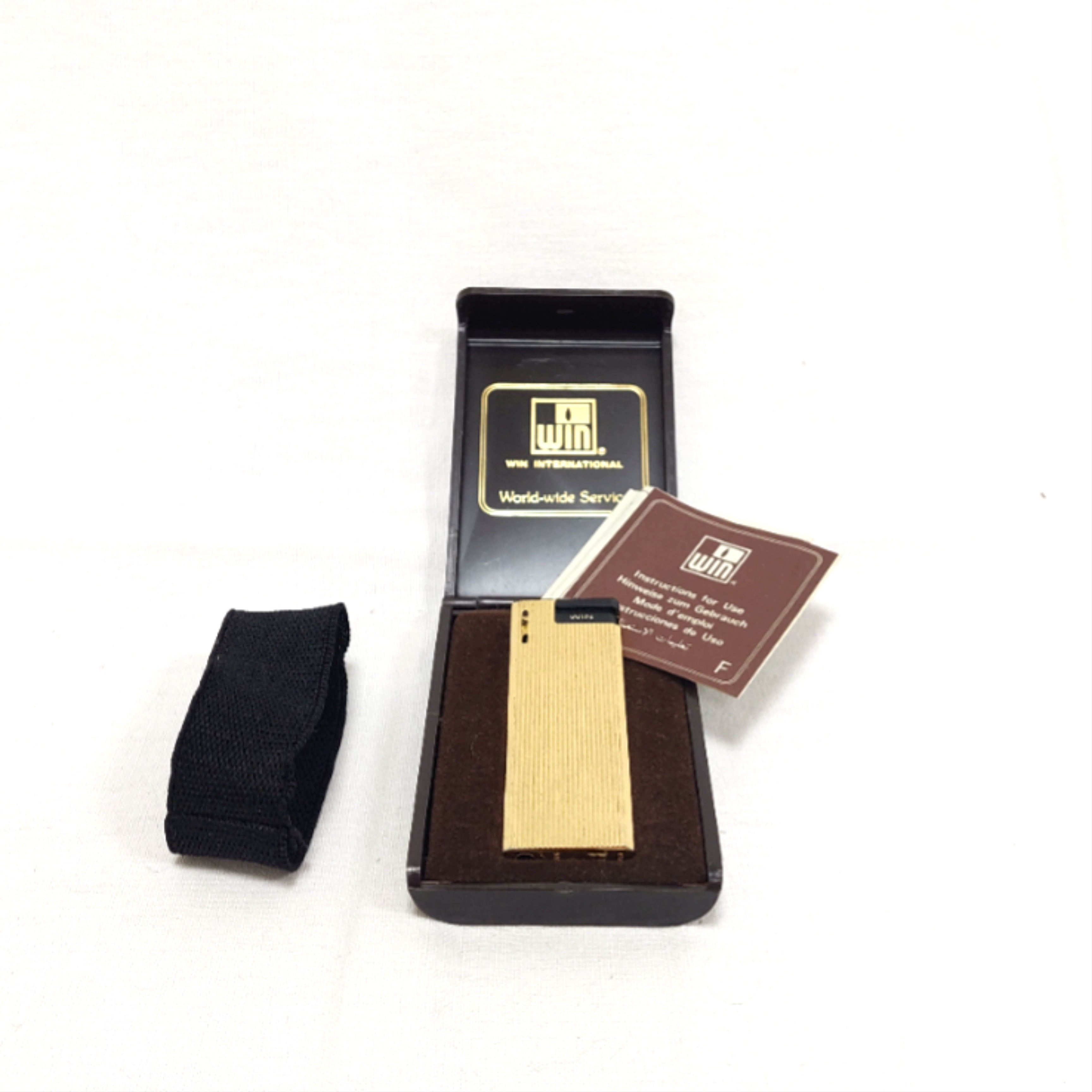 Briquet de collection - Win international- world-wide service - numéroté 50 - made in Japan Bon état -  reconditionné disponible sur Label Emmaüs