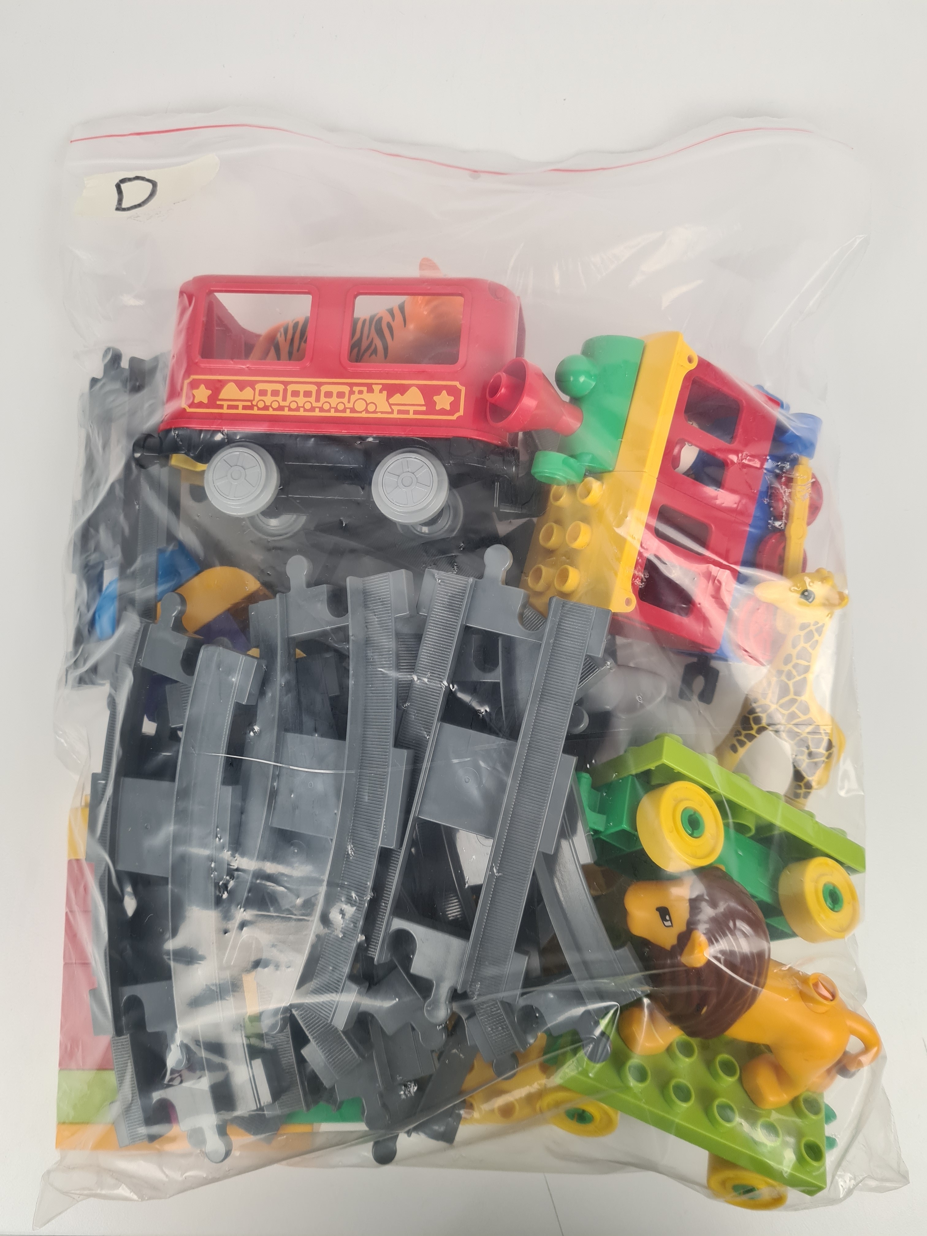 Lego Duplo - Sachet 1kg de blocs de construction en vrac avec 1train, 1 personnage et des animaux- +12 mois - Photo 0