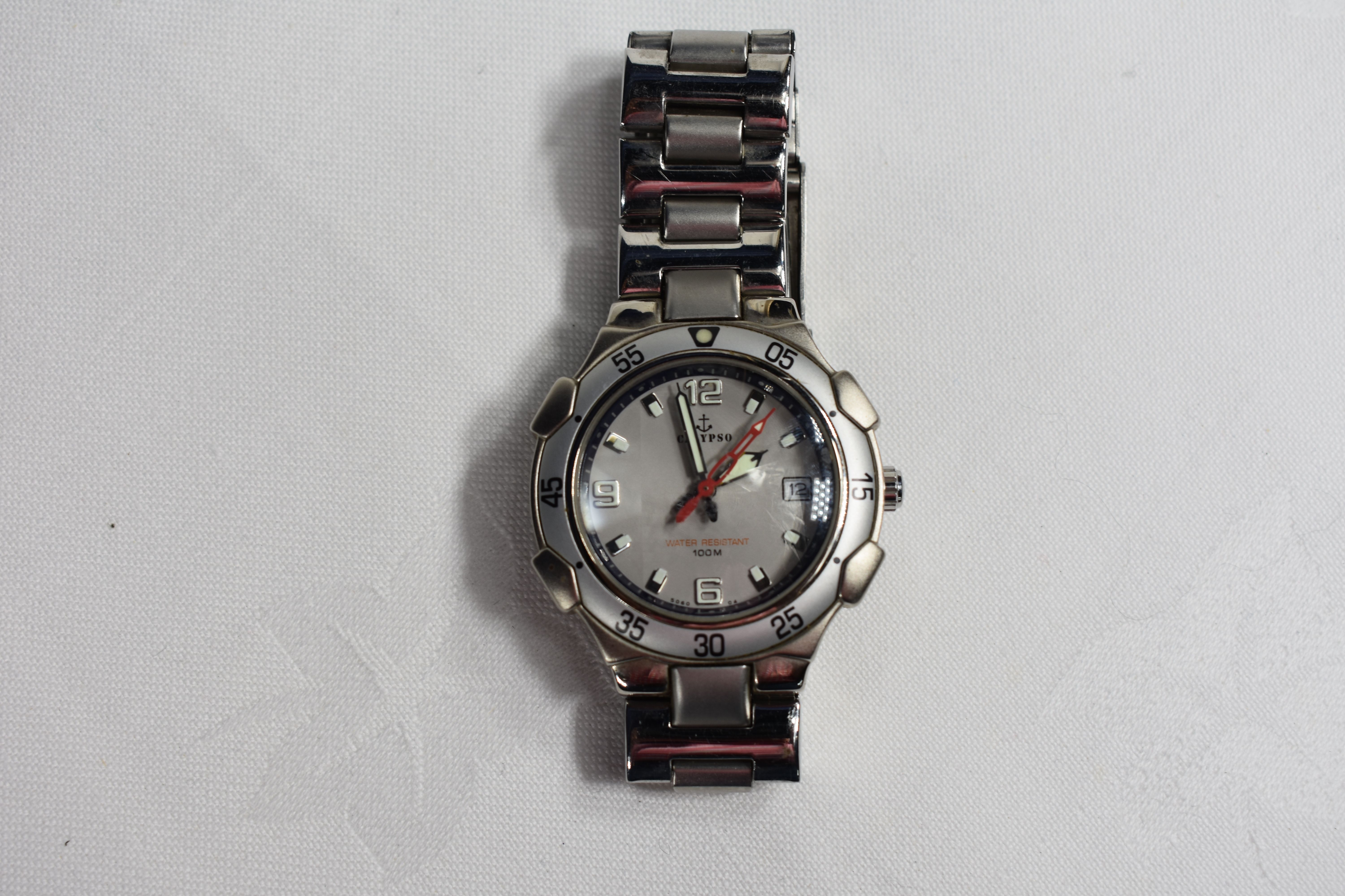 Voir photo 3 de montre Calypso vintage à quartz étanche 100m, bracelet métal (fonctionne) montre Calypso vintage à quartz étanche 100m, bracelet métal (fonctionne) Bon état - Vue 3 -